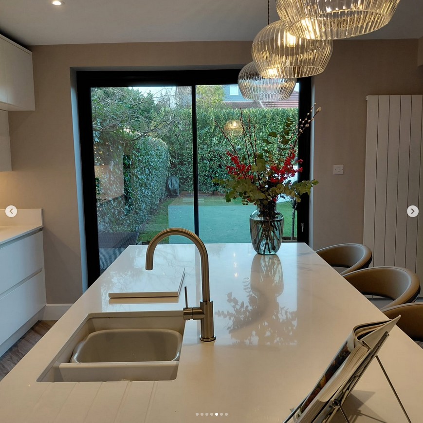 Modern kitchen with marble island and brass fixtures