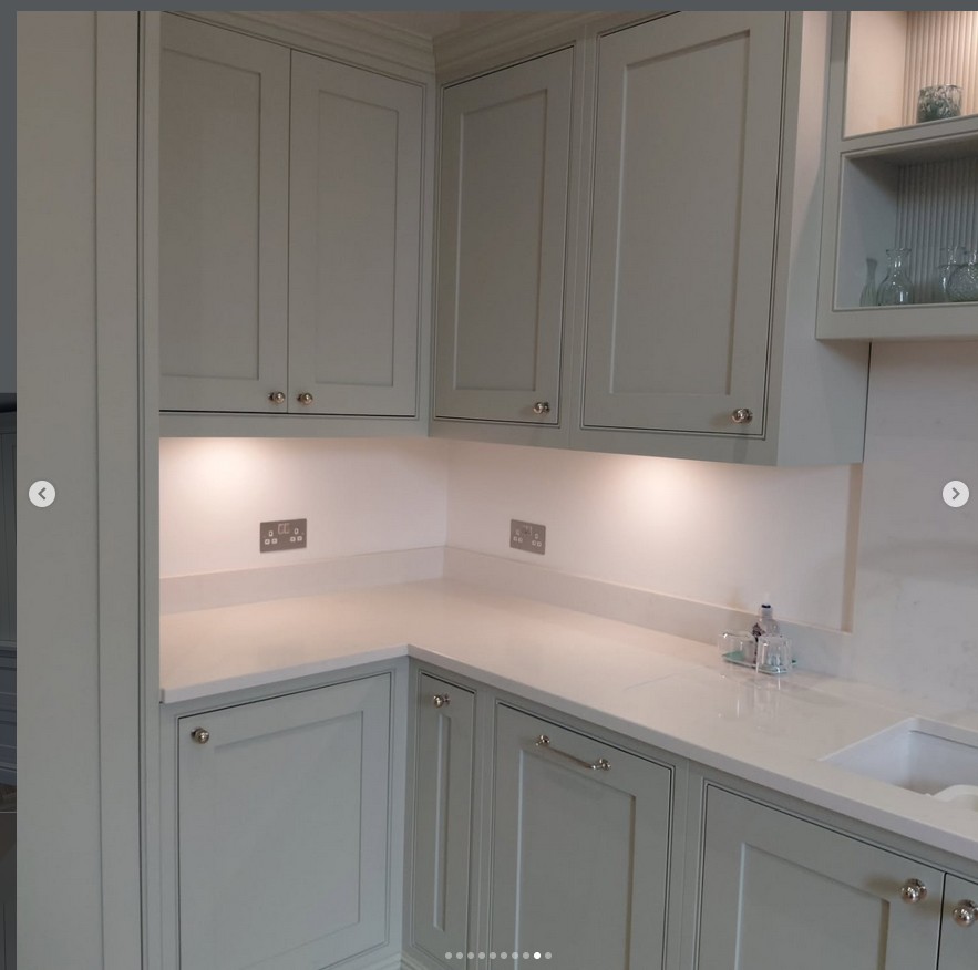 Traditional kitchen in soft green with marble worktops