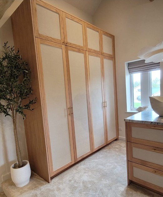 Fitted wardrobe with oak frame and white panel inserts