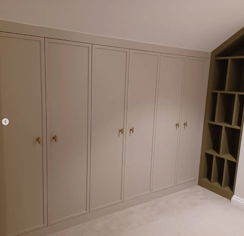 Floor to ceiling fitted wardrobes with brass handles