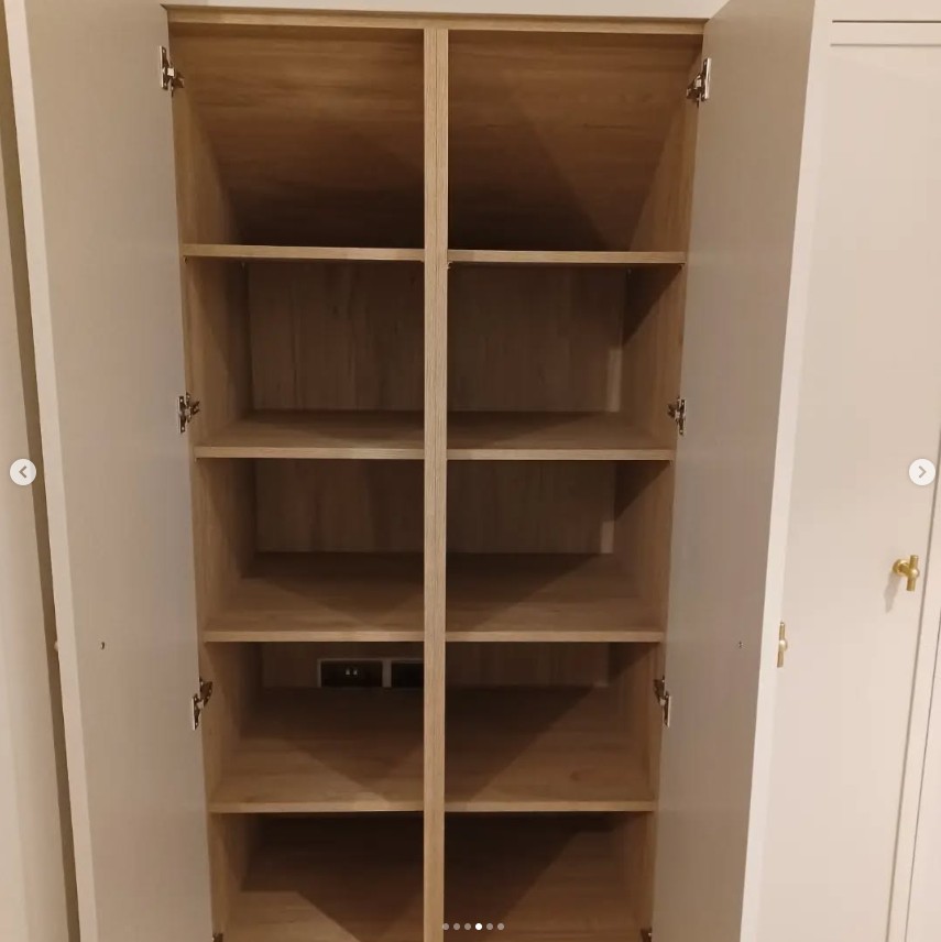 Built-in wardrobe with shelving and integrated power sockets
