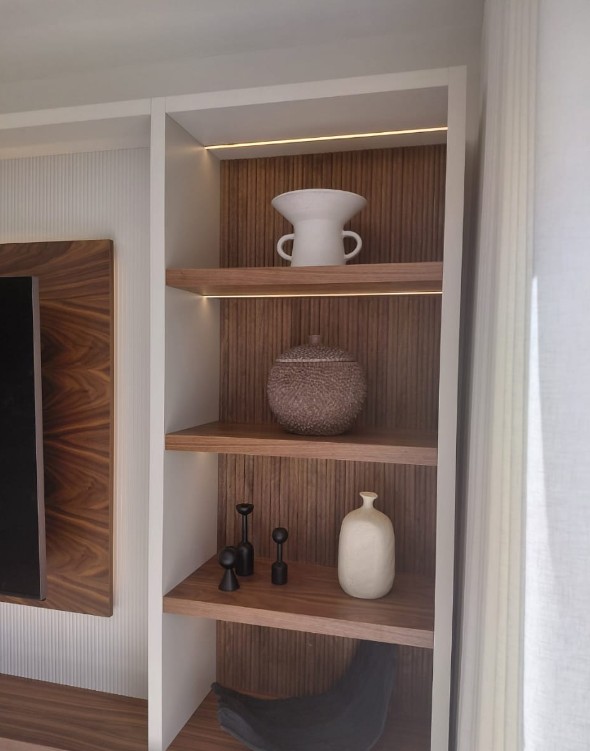 Close-up detail of fluted panel texture with LED-lit display shelving