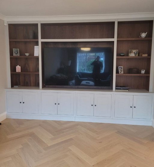Traditional media wall with white base cabinets and walnut open shelving
