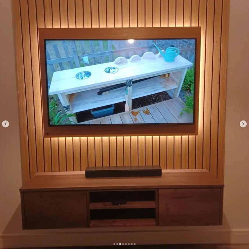 Contemporary media wall with slatted wood panel surround