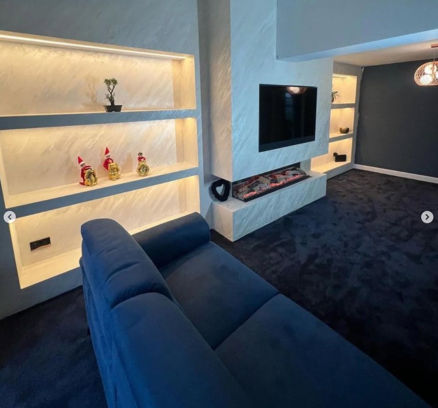 Modern media wall with marble-effect panels and ambient lighting