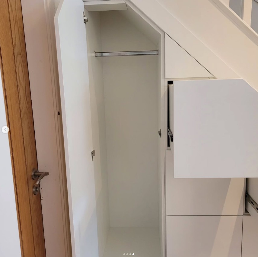 Under stairs tall cupboard with hanging rail and shelving