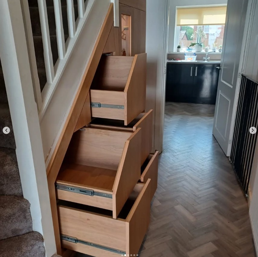 Natural oak under stairs storage with cascading pull-out drawer system