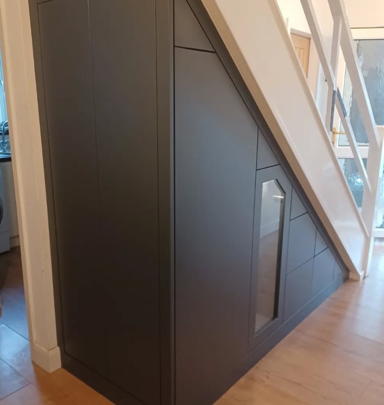 Contemporary charcoal grey under stairs storage with handleless design