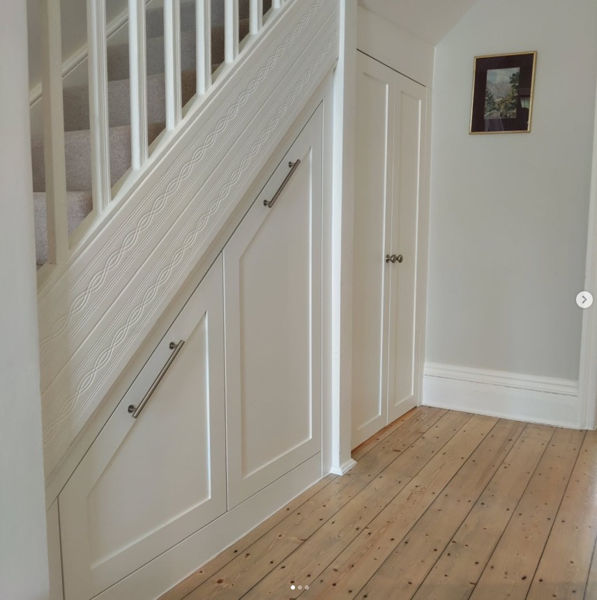Under stairs storage with shaker-style doors and bar handles