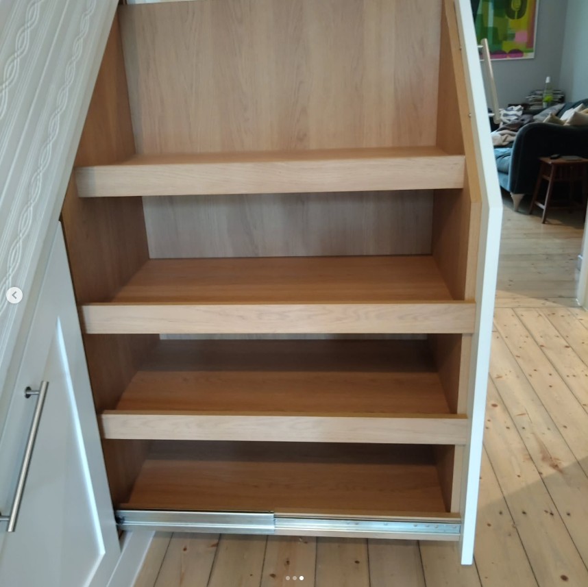 Interior view of under stairs storage with adjustable shelving